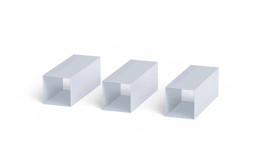 Three KTP laser crystals in gray color in the shape of rectangular prisms